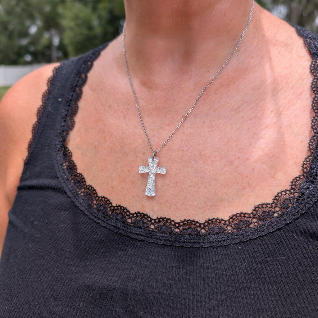 Silver dichroic cross pendant with coin for scale