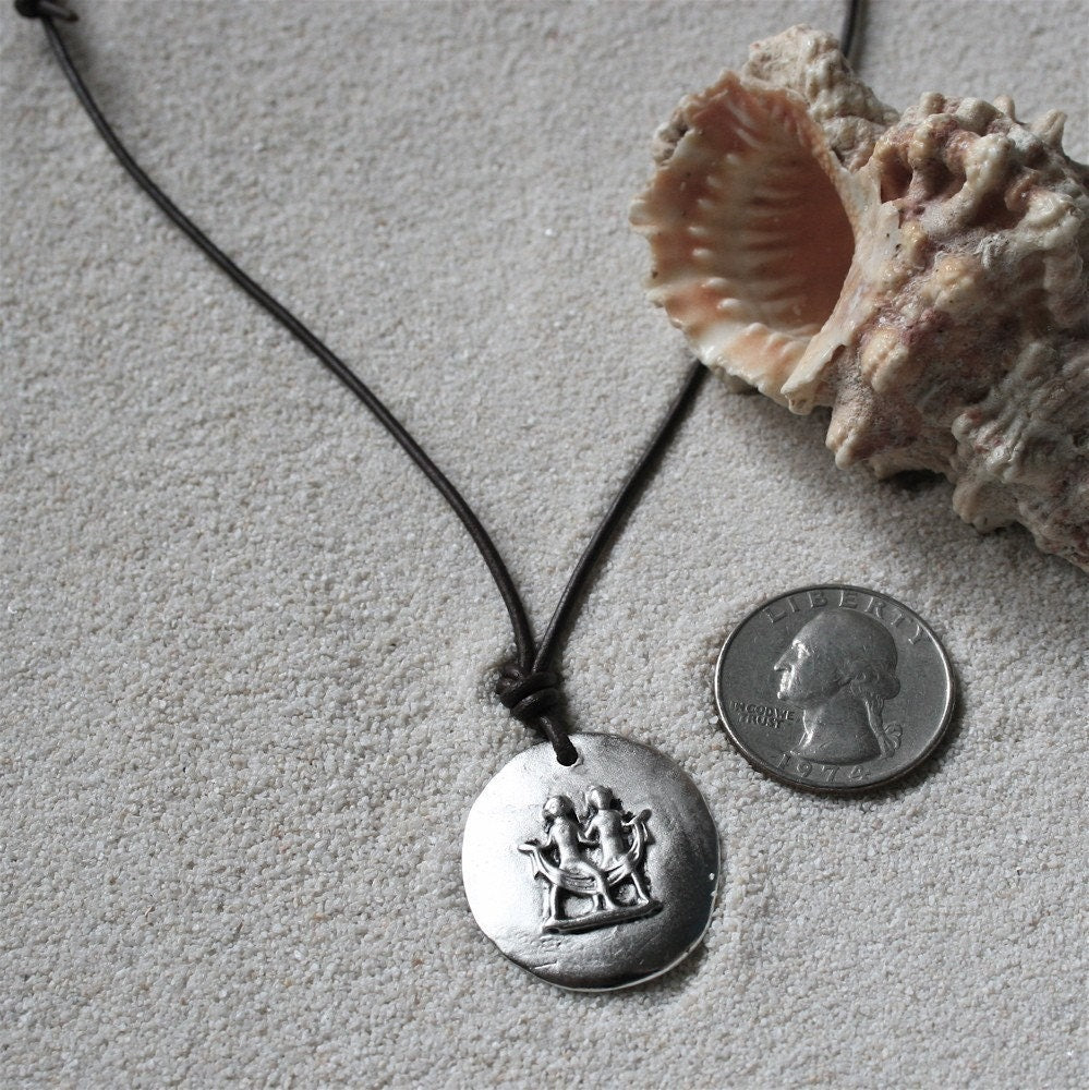 Gemini zodiac charm necklace, white metal on leather cord