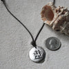Gemini zodiac charm necklace, white metal on leather cord
