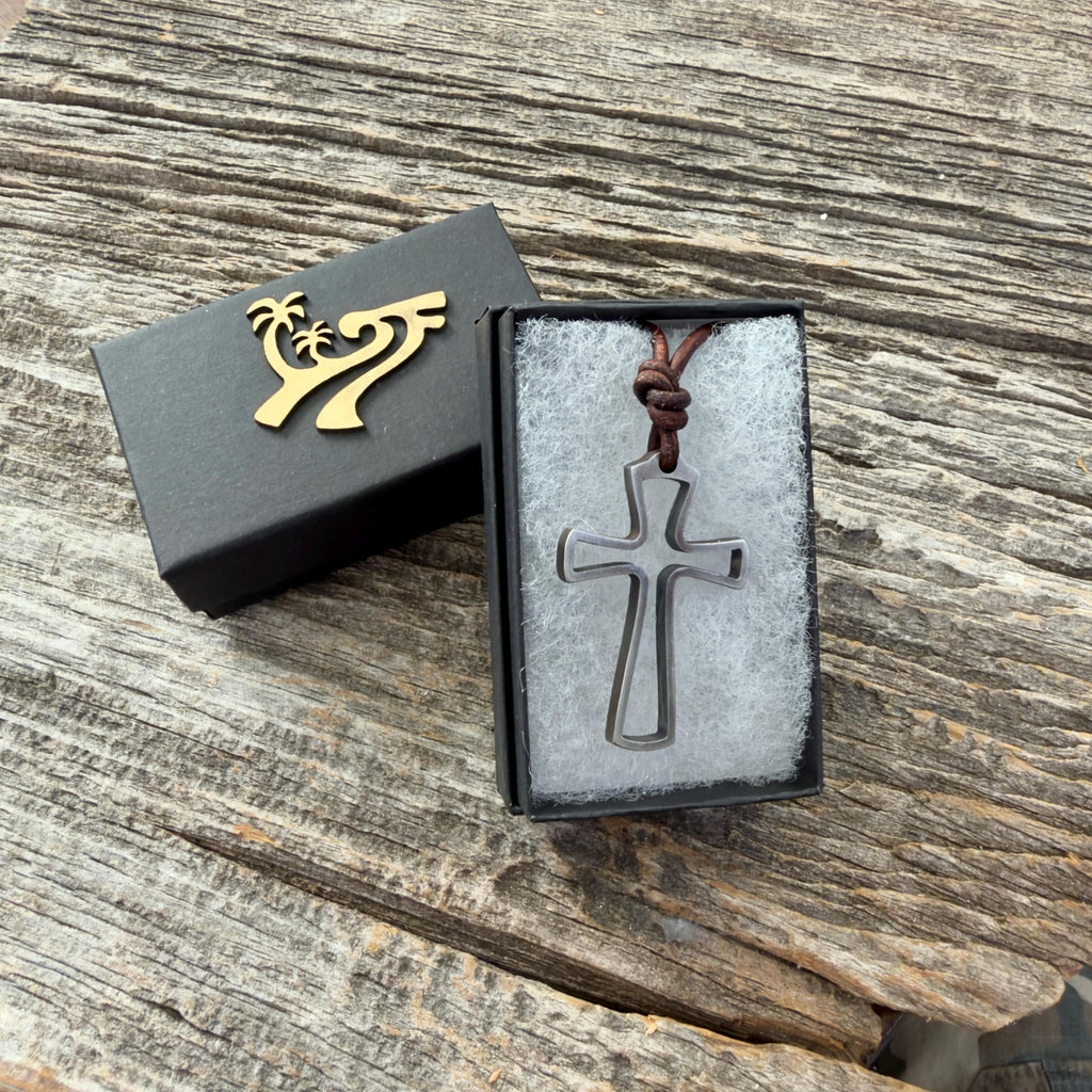 Mens open cross necklace in the black Zulasurfing gift box with gold logo on weathered wood, a ready-to-give Christian gift for him