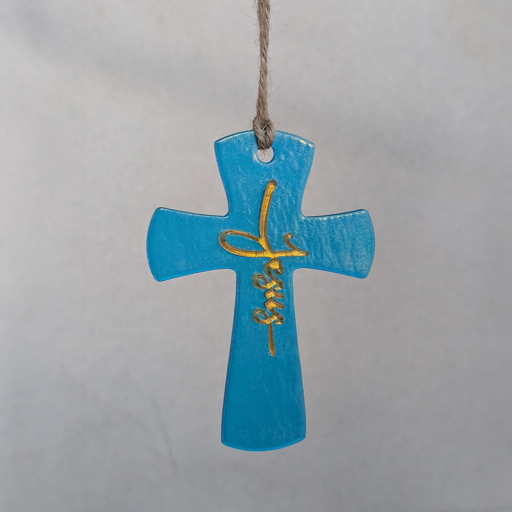 Turquoise glass cross ornament with the name Jesus in gold script, handmade fused glass