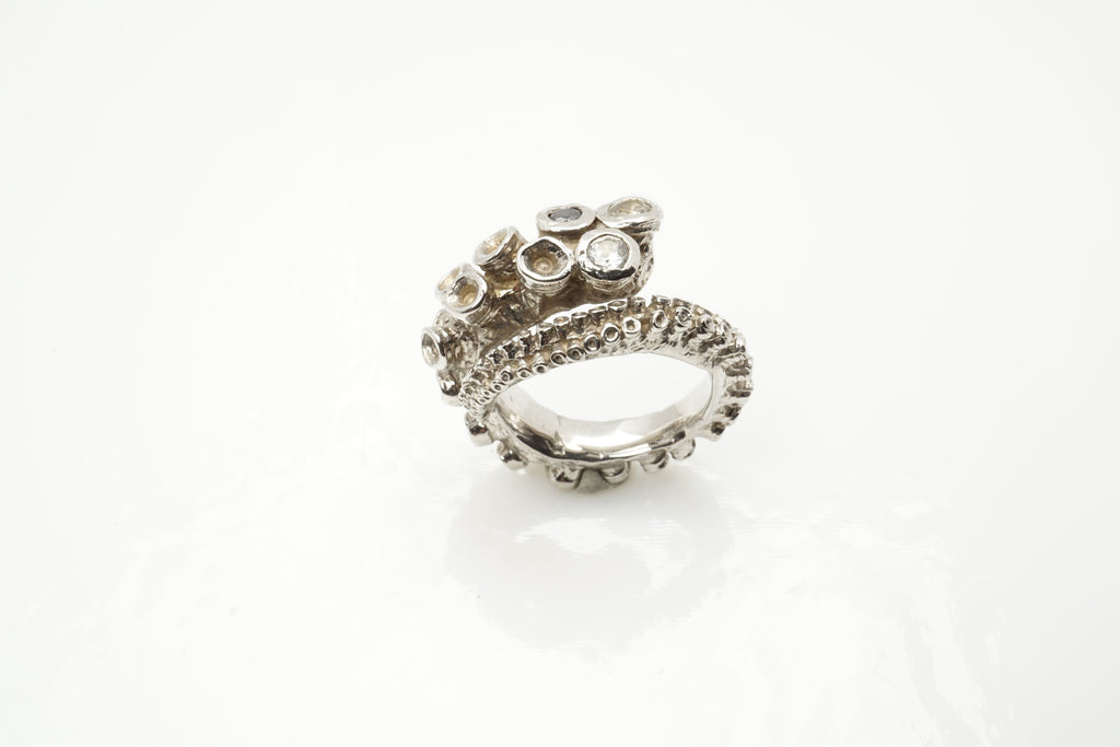 14k white gold octopus tentacle ring product photo, angled view showing sapphires and black diamond