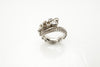 14k white gold octopus tentacle ring product photo, angled view showing sapphires and black diamond