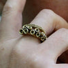 Octopus tentacle ring in solid yellow brass, adjustable open shank, front view