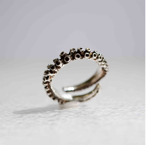Small octopus tentacle ring in sterling silver, thin adjustable band, front view