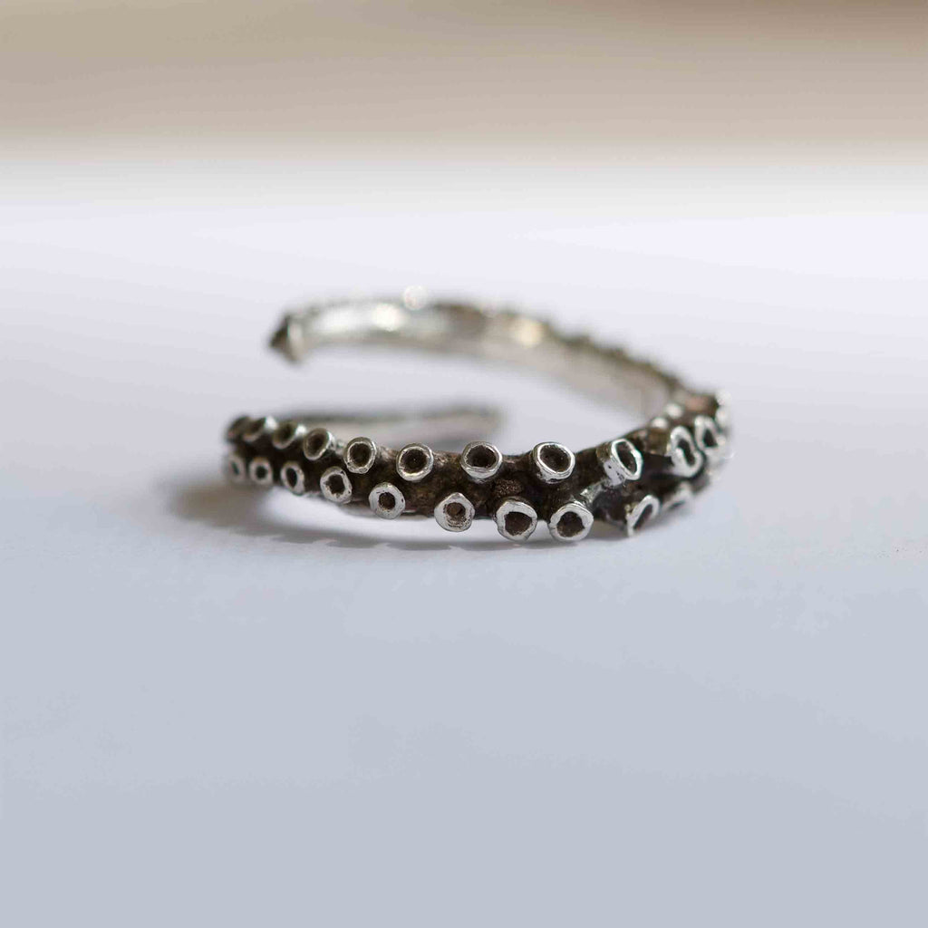 Small octopus tentacle ring in sterling silver, close-up design detail