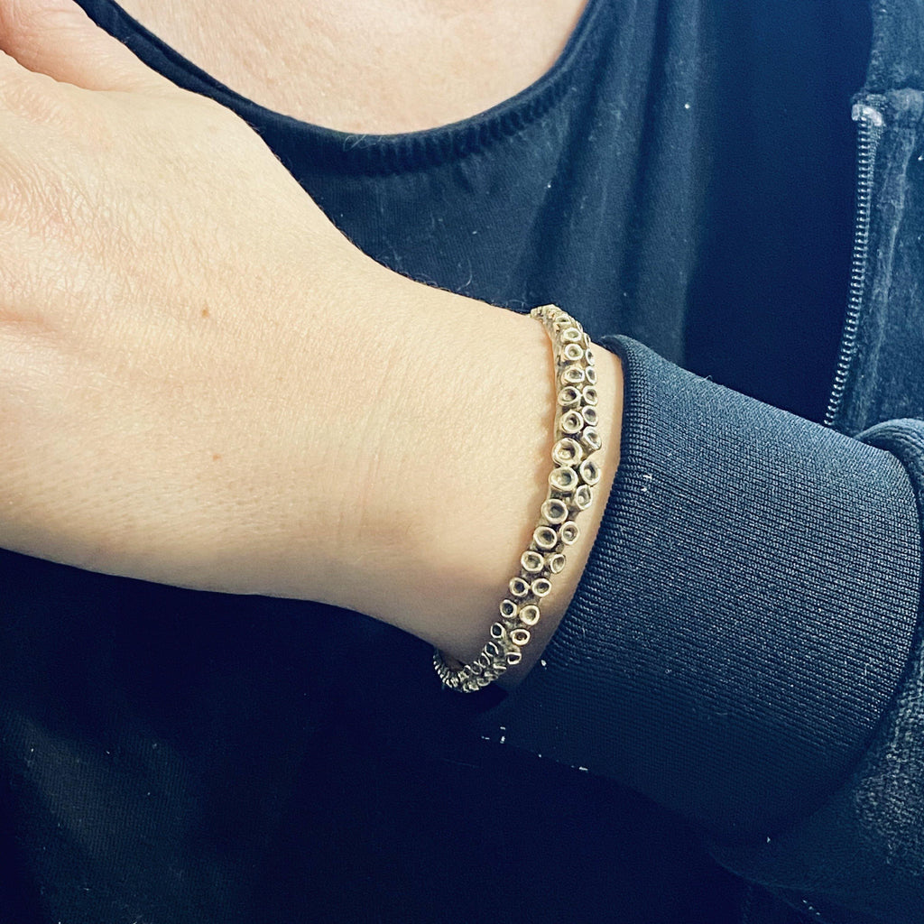 Octopus tentacle cuff bracelet, close-up of suction cup texture