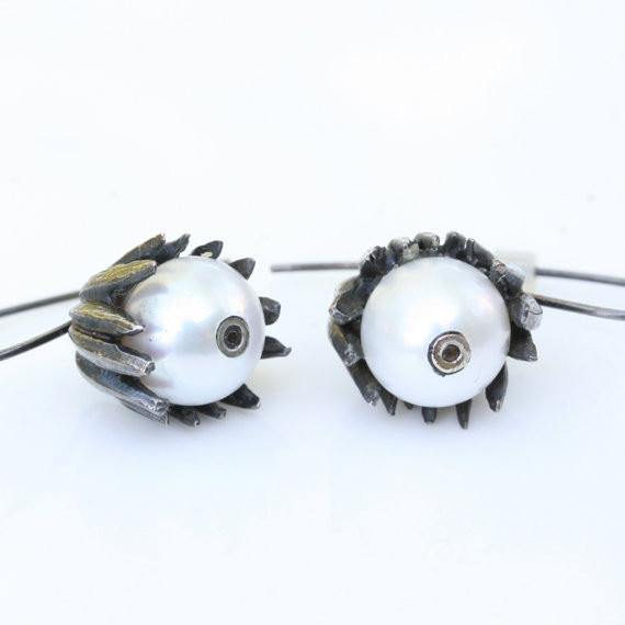 Octopus tentacle earrings with pearl and brown diamond, close-up
