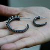 Close-up of octopus tentacle hoop earring suction cup detail