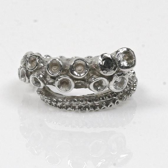 14k white gold octopus tentacle ring with white sapphires and a black diamond set in the suction cups, front view