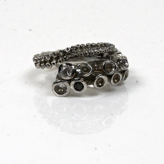 Close-up of octopus tentacle ring suction cups set with white sapphires and black diamond