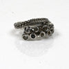 Close-up of octopus tentacle ring suction cups set with white sapphires and black diamond