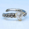 Close-up of white topaz stone on 14k gold octopus tentacle ring