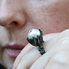 Octopus tentacle ring with pearl set in flower pod detail