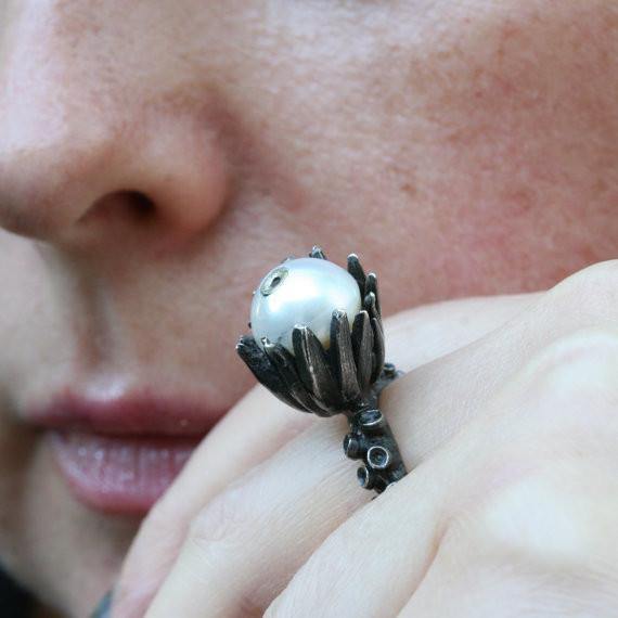 Octopus tentacle ring with pearl set in flower pod detail