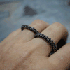 Octopus tentacle two-finger ring in sterling silver, close-up of adjustable band