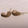 Small octopus tentacle earrings worn in ear