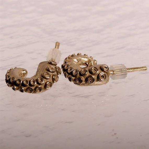 Small octopus tentacle earrings worn in ear